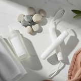 Toe Towel Duo lifestyle image with cleanser bottle and white towel